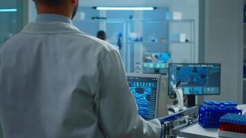 Scientist working in laboratory analysing test trial vaccine checking drug data standing in front of pc. Group of chemists examining virus evolution using high tech for research diagnosis video
