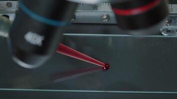 Micro pipette putting blood sample on microscope to test dna and genetic. Chemist using dropper to analyze substance with microscopic tool and magnifying glass lens in laboratory. Close up video