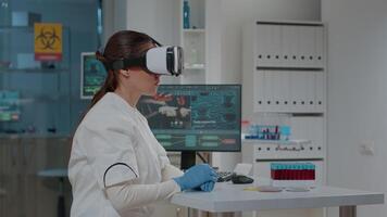 Lab worker using vr goggles with 3d projection in science laboratory. Woman scientist working with virtual reality headset to develop biochemistry simulation for analysis. Futuristic innovation video