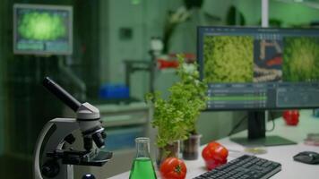 Close up of scientific research laboratory with glass test tubes, flask, microscope and sapling on workplace table. Biochemistry lab is prepared for biological experiment video