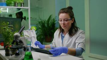 Chemist scientist taking dna solution from test tube with micropipette putting in petri dish checking biology expertise. Biologist specialist researcher working in biotechnology laboratory video