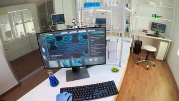 FPV of biologist doctor checking DNA image typing on pc, while colleague bringing tubes with samples, Scientists examining vaccine evolution in medical lab using high tech for scientific research. video