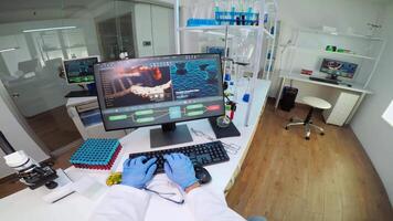 POV of chemist putting protection glasses, working at computer examining various bacteria in laboratory. Doctors analysing vaccine evolution using high tech researching diagnosis against covid19 virus video