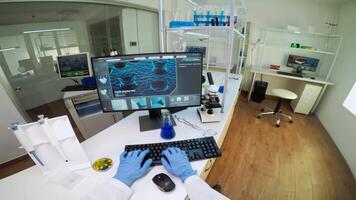 Chemist doctor holding test tube with blood sample talking with researcher, entering datas in pc. Team of scientists analysing vaccine evolution using high tech researching diagnosis against covid19 . video