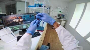 POV of scientist using micropipette for analysing blood sample putting in petri dish. Team of researchers examining virus evolution using high tech for vaccine development against covid19 video