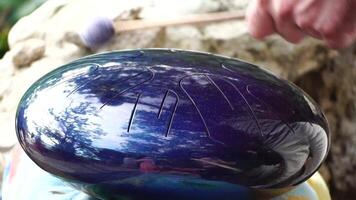 A Close-Up View of a Handpan Being Played with a Mallet video