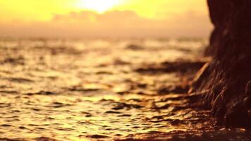 Golden sunset on the beach. Foamy waves rolling towards golden sand beach under low warm sun light. Slow motion. Nobody. Holiday recreation concept. Abstract nautical summer ocean sunset nature. video