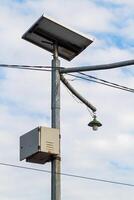 metal pole with common lights and cables with sky background photo