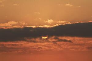 Close up view of sun hidden behind clouds photography photo