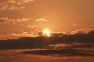 Close up view of sun hidden behind clouds photography photo