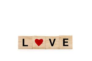 Hand place wooden blocks with LOVE text and red heart isolated on white background. Love symbol with copy space and clipping path. photo