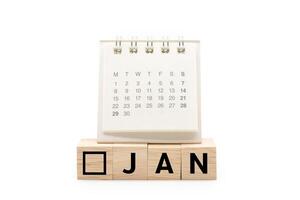 Calendar on Wooden blocks with JAN text isolated on white background. January and Calendar concept. Copy space. photo
