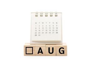Calendar on Wooden blocks with AUG text isolated on white background. August and Calendar concept. Copy space. photo