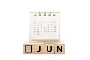 Calendar on Wooden blocks with JUN text isolated on white background. June and Calendar concept. Copy space. photo