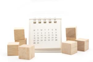 Blank wooden blocks and Calendar on white background with copy space for input wording and infographic icon. Wooden blocks with Calendar. photo