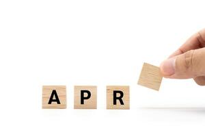 Hand place wooden blocks with APR text isolated on white background. April and Calendar concept. Copy space. photo