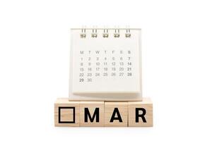 Calendar on Wooden blocks with MAR text isolated on white background. March and Calendar concept. Copy space. photo