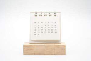 Blank wooden blocks and Calendar on white background with copy space for input wording and infographic icon. Wooden blocks with Calendar. photo