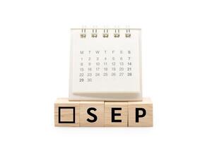 Calendar on Wooden blocks with SEP text isolated on white background. September and Calendar concept. Copy space. photo
