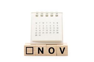 Calendar on Wooden blocks with NOV text isolated on white background. November and Calendar concept. Copy space. photo