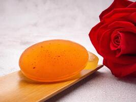 Organic soaps homemade with ingredients are honey placed on a bamboo plate with a gray stone background. Soap protection or prevent acne, bacteria in both body, and facial. Concept of healthcare photo