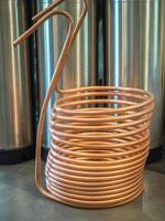 A copper immersion heat exchanger for use in the craft beer process. Selective focus. Home brewing process photo