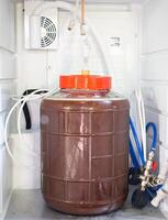 Close-up of craft beer and foam in a fermentation container. photo