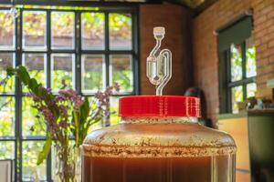 Close-up of craft beer and foam in a fermentation container. photo