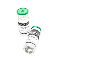 The covid-19 vaccine in glass bottles for prevention, immunization, and treatment from coronavirus infection on white background. Space for text. Concept of medical and vaccine photo