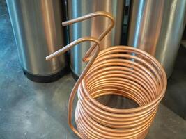 A copper immersion heat exchanger for use in the craft beer process. Selective focus. Home brewing process photo