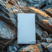 Blank white canvas on rocky surface with natural textures, ideal for creative designs and mockups. photo