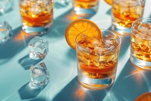 Refreshing whiskey cocktails with ice and orange slices on a blue background, perfect for summer parties and drink presentations. photo