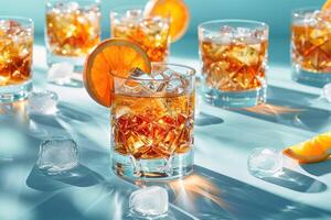 Refreshing cocktails with orange slices and ice cubes on a blue background, perfect for a summer party or bar advertisement. photo