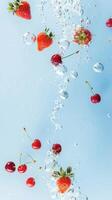 Fresh strawberries and cherries falling in clear water with bubbles on a light blue background, creating a refreshing and vibrant scene. photo