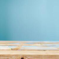 Wooden table with a light blue gradient background, perfect for product display or presentation. Ideal for creative designs and backdrops. photo