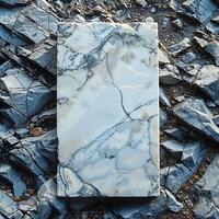 Marble slab placed on rocky background, showcasing intricate patterns and textures of the marble surface. photo