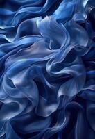 Elegant abstract blue silk fabric flowing with soft waves and folds creating a luxurious and dreamy background texture. photo