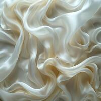 Elegant and luxurious white silk fabric with soft, flowing folds creating a dreamy and smooth texture. photo
