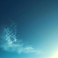 Calm blue sky with scattered white clouds and a touch of sunlight, capturing the serenity and vastness of the atmosphere. photo