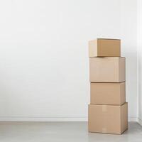 Stack of cardboard boxes against a white wall in an empty room, ideal for moving, storage, or packaging concepts. photo