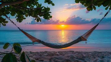 Scenic tropical beach sunset with a hammock strung between trees, perfect for relaxing and enjoying nature's beauty. photo