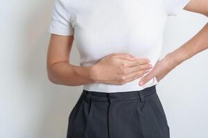 Woman having back pain. Urinary system and Stones, Cancer, world kidney day, Chronic kidney stomach, liver pain and pancreas concept photo