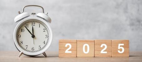 Happy New Year with vintage alarm clock and 2025 block. Christmas, New Start, Resolution, countdown, Goals, Plan, Action and Motivation Concept photo