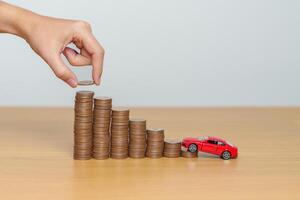 Money Saving, Car Insurance, Financial, vehicle Repair and Maintenance concepts. coins stack and piggy bank with Auto model, Money stack Counting arrangement for deposit and Automobile Tax photo