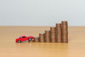 Money Saving, Car Insurance, Financial, vehicle Repair and Maintenance concepts. coins stack and piggy bank with Auto model, Money stack Counting arrangement for deposit and Automobile Tax photo