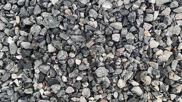 Crushed grey stone on the ground texture background, Crushed rock close up, Crushed stone road building material gravel texture, Garden gravel background stone landscaping photo