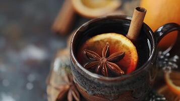 Mulled wine holiday with orange and cinnamon sitting in a cup photo