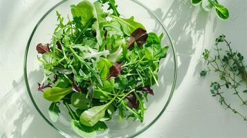 Fresh organic mixed greens salad on light background photo