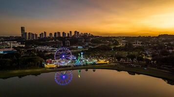 Curitiba in Parana, Brazil. Aerial View. Wonderful sunset with views of buildings and Tangua Park. Lake with reflection. photo