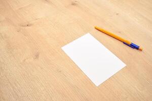 blank a 4 paper and a pen on a table photo
